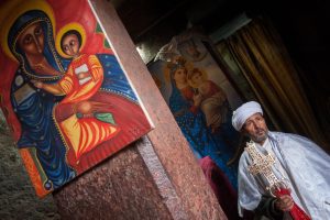 Coptic priest in monolithic stone church lalibela, ethiopia july 2016